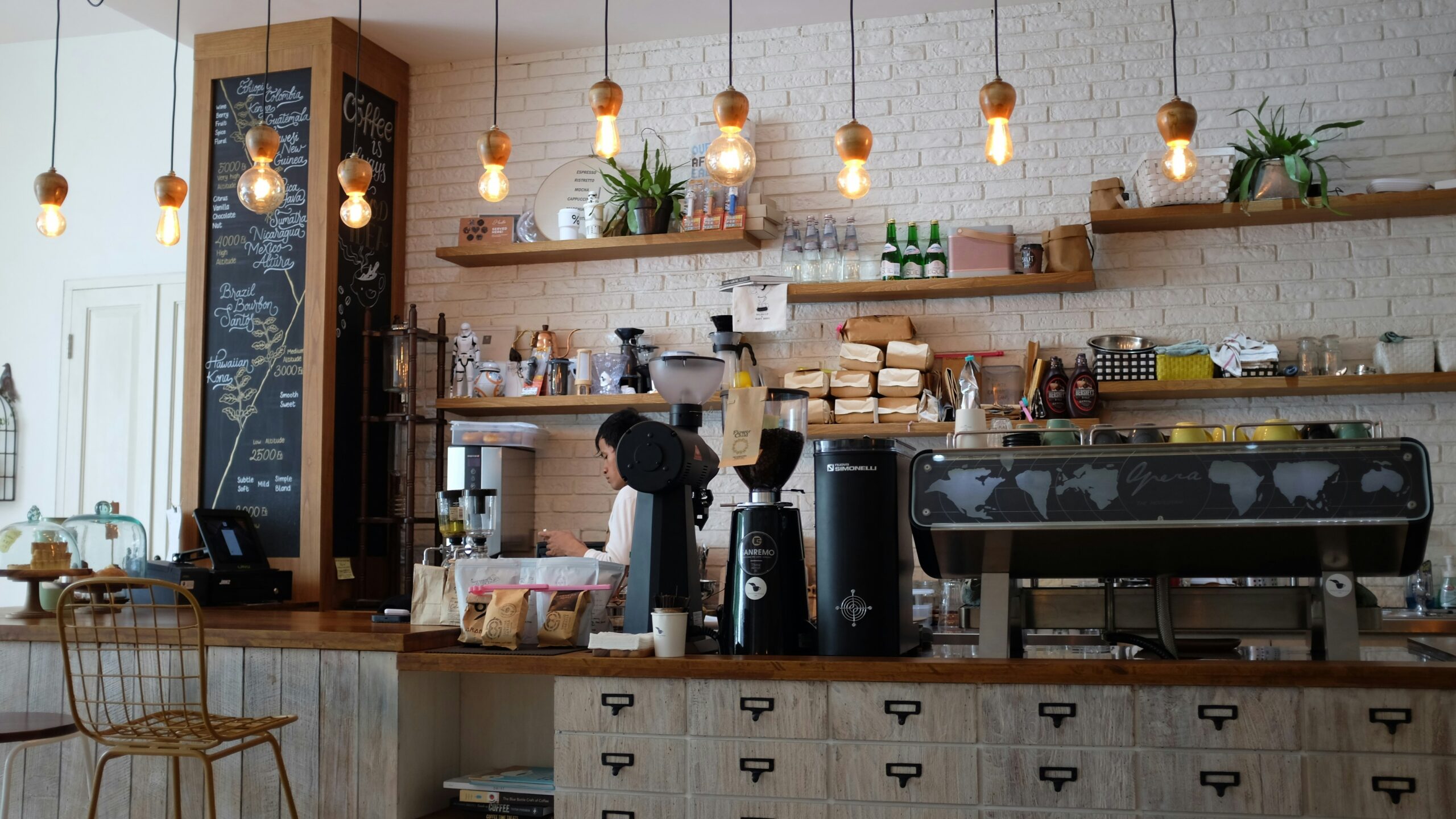 A cozy local coffee shop with inviting outdoor seating, colorful decorations, and customers enjoying their drinks, representing community engagement and small business growth.